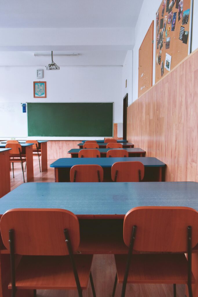 pexels-photo-2675061-2675061 A tranquil empty classroom with wooden furniture and a green chalkboard, perfect for educational themes.